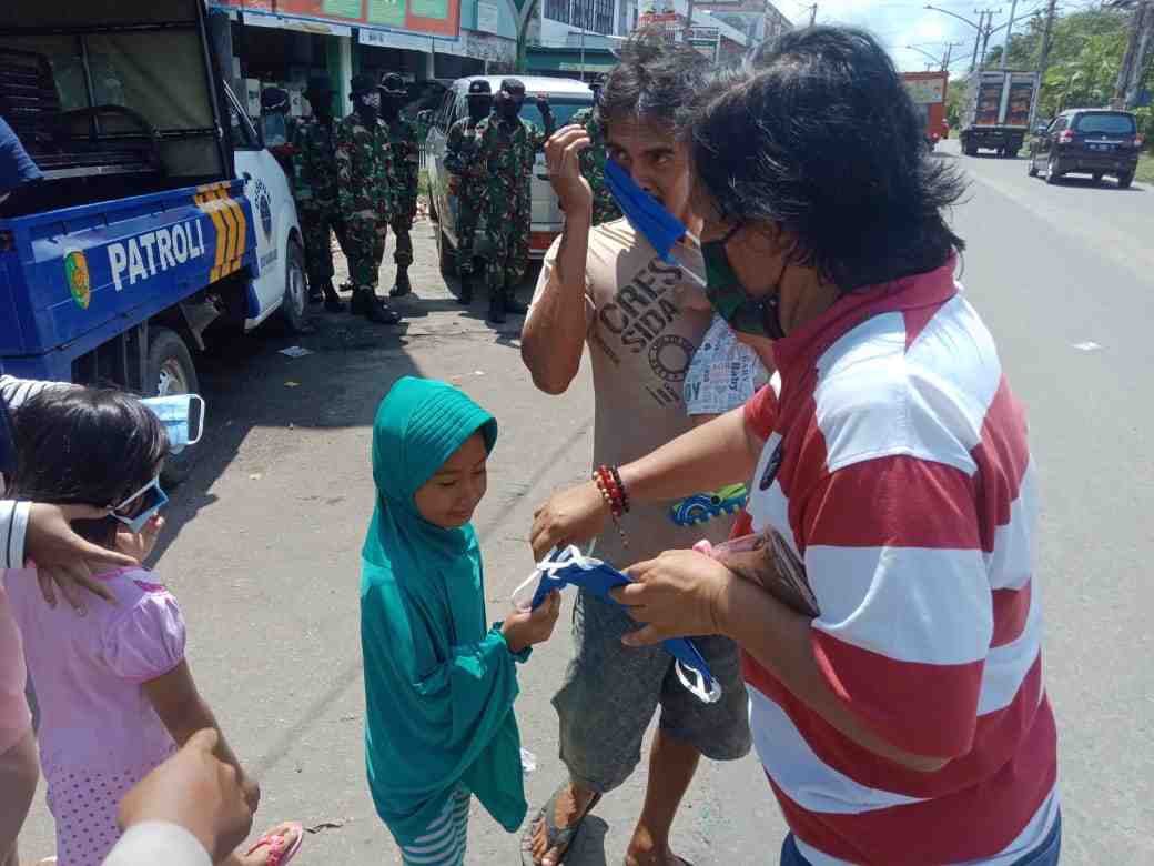 MEMBERIKAN MASKER UNTUK ANAK-ANAK