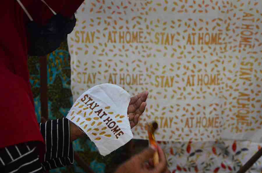 PRODUKSI MASKER BERTULISKAN STAY AT HOME